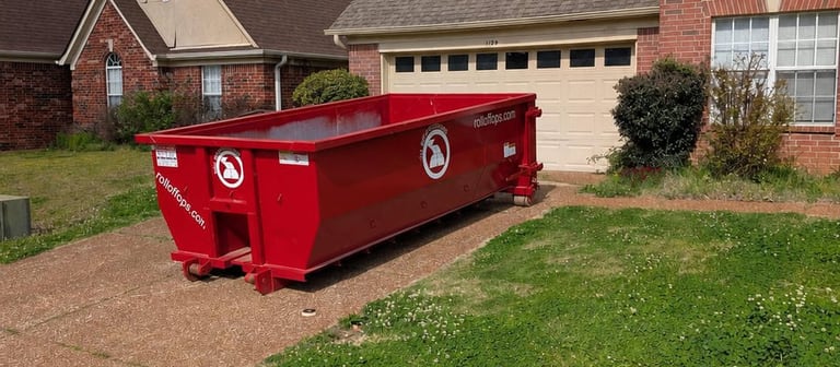 Red 15-yard Roll Off Operations dumpster positioned on a residential driveway