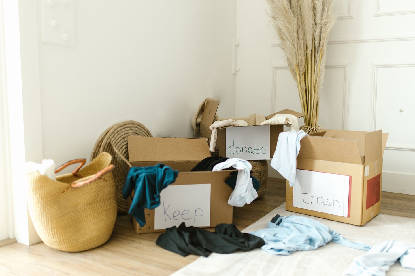 Boxes labeled keep, donate, and trash for a garage cleanout