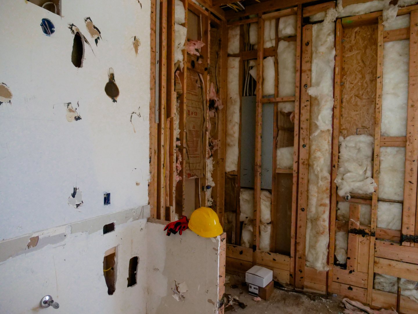Partially demolished room with exposed framing during a renovation